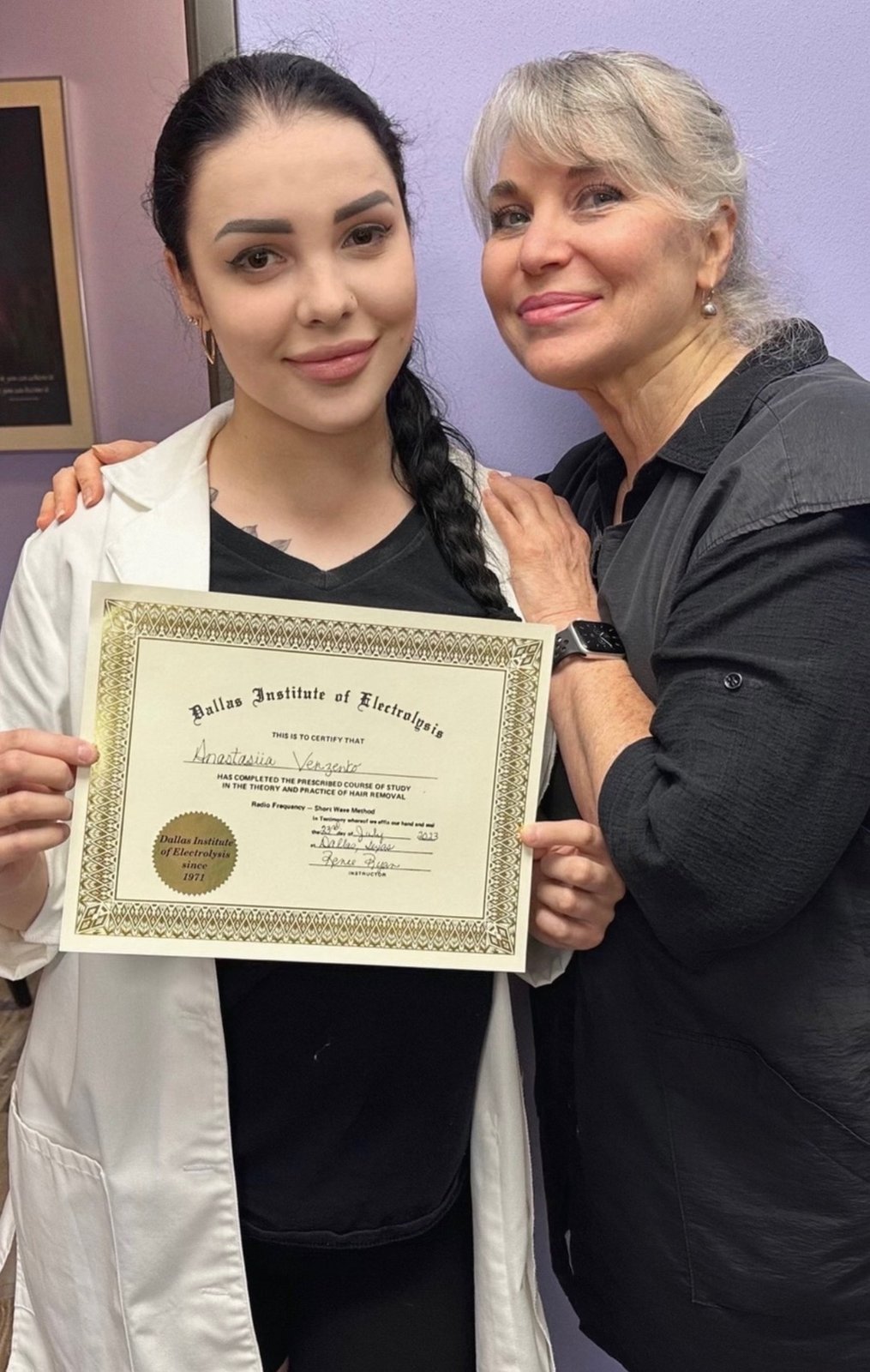 Graduate holding her Dallas Institute of Electrolysis Certificate of Completion